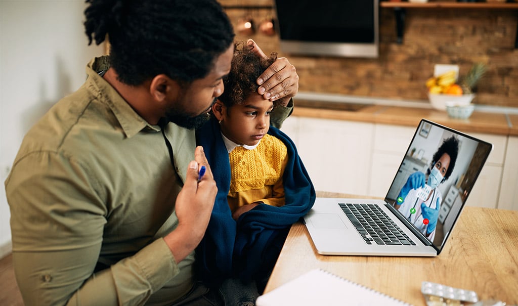 Father and daughter attending a telemedicine appointment